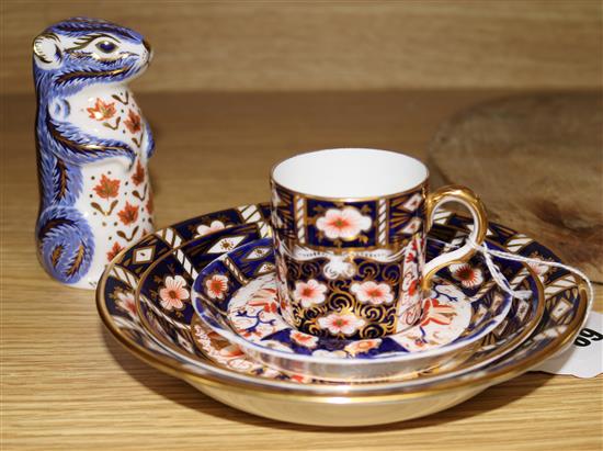 A Royal Crown Derby paperweight, a cup and 3 saucers